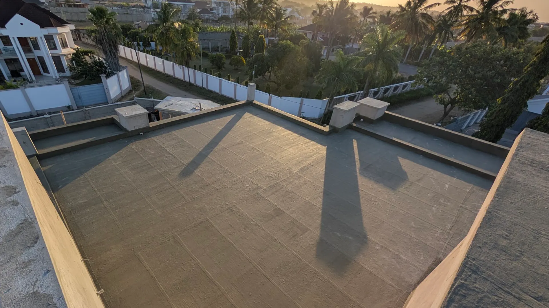 Residential building rooftop undergoing waterproofing works in Dar es Salaam, Tanzania.